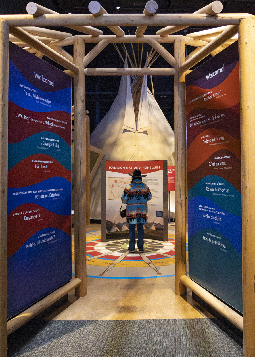 A person stands in the Arbor of the Sovereign Nations Homelands