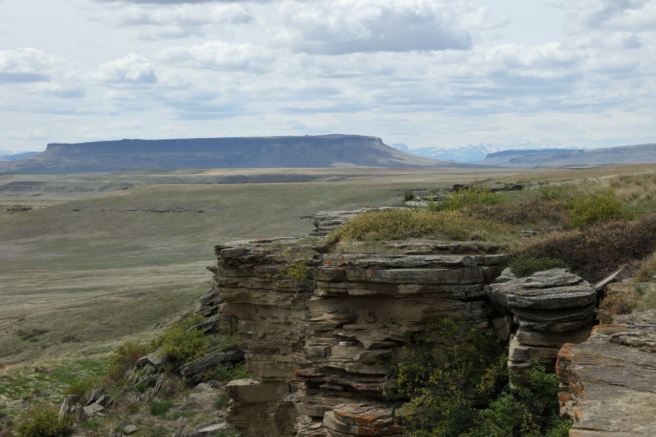 Photograph of First Peoples Buffalo Jump State Park, Ulm, Cascade County, Montana in the foreground with a view of Square Butte in the background